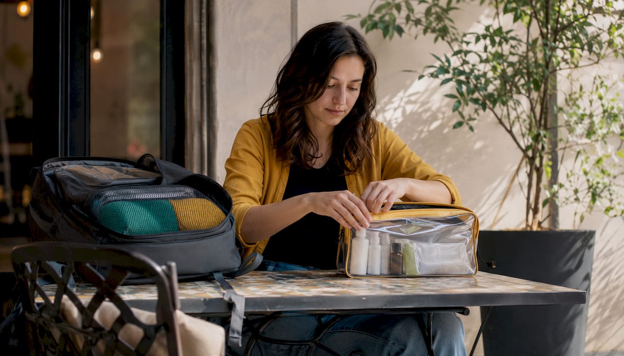 Traveler packing TSA-compliant toiletries bag
