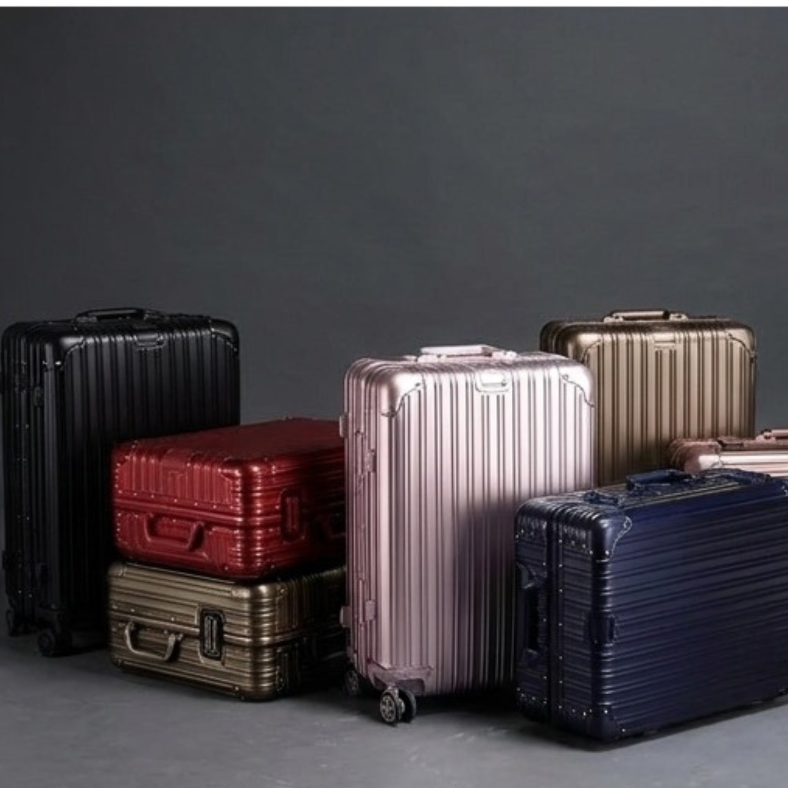 Full range of SPRITZ™ Bourdain Suitcase aluminum hard-shell colorways grouped together