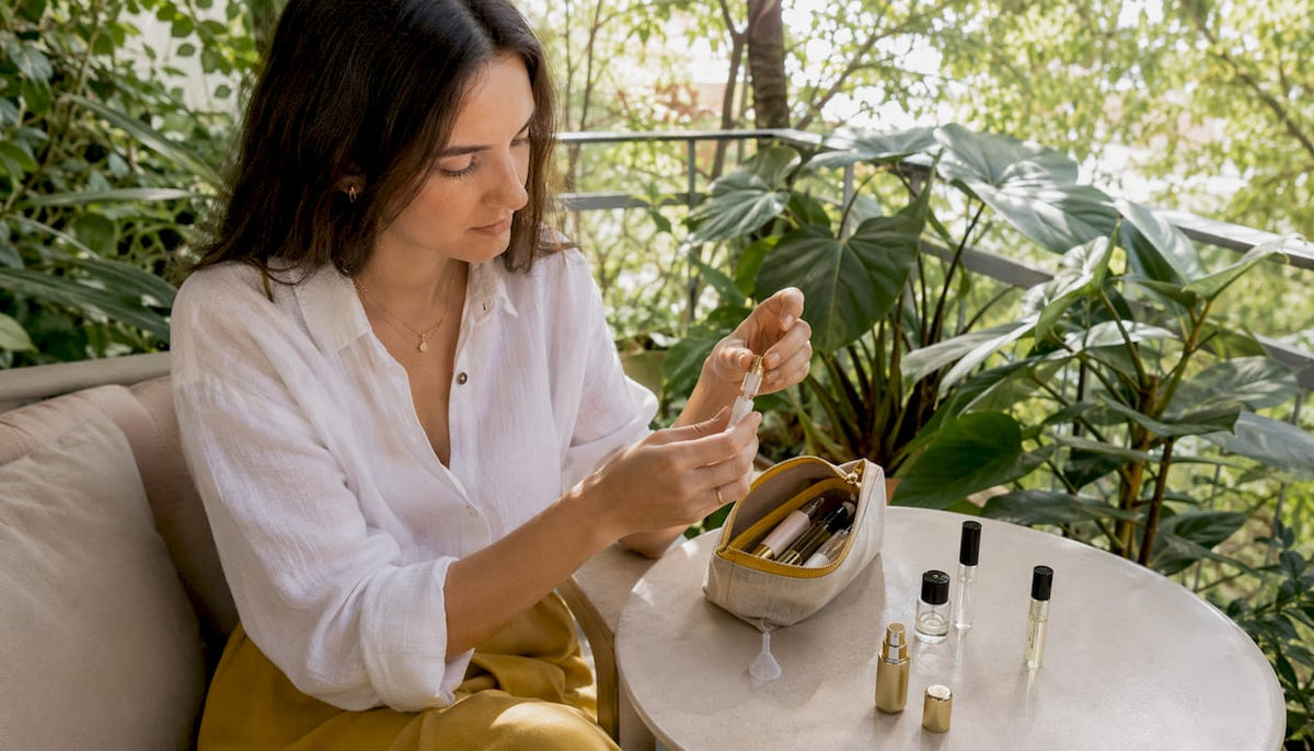 Woman packing perfume atomizers for travel