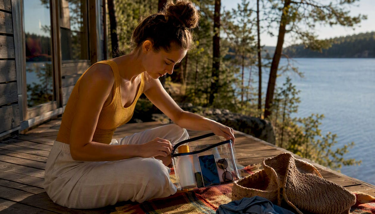 Woman packing waterproof pouch near beach