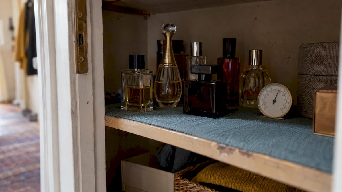 Perfume bottles stored in a shaded cupboard