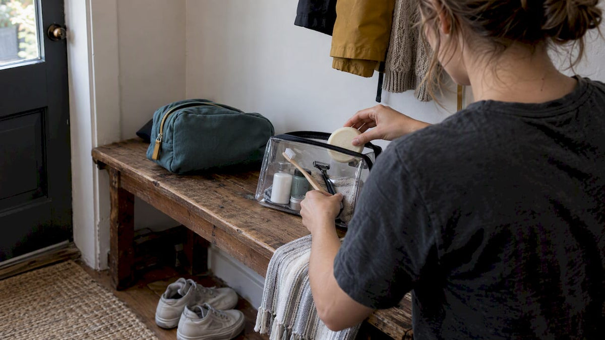 Traveler packing a compact toiletries kit